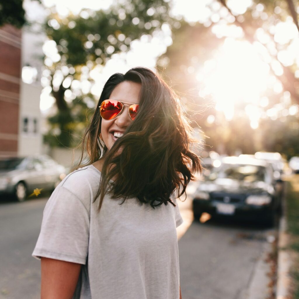 Photo by Matthew Hamilton woman wearing white T-shirt smiling