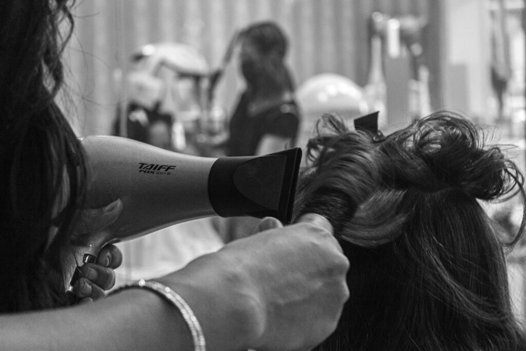 Photo by Anabelle Carite grayscale photo of woman holding hair blower